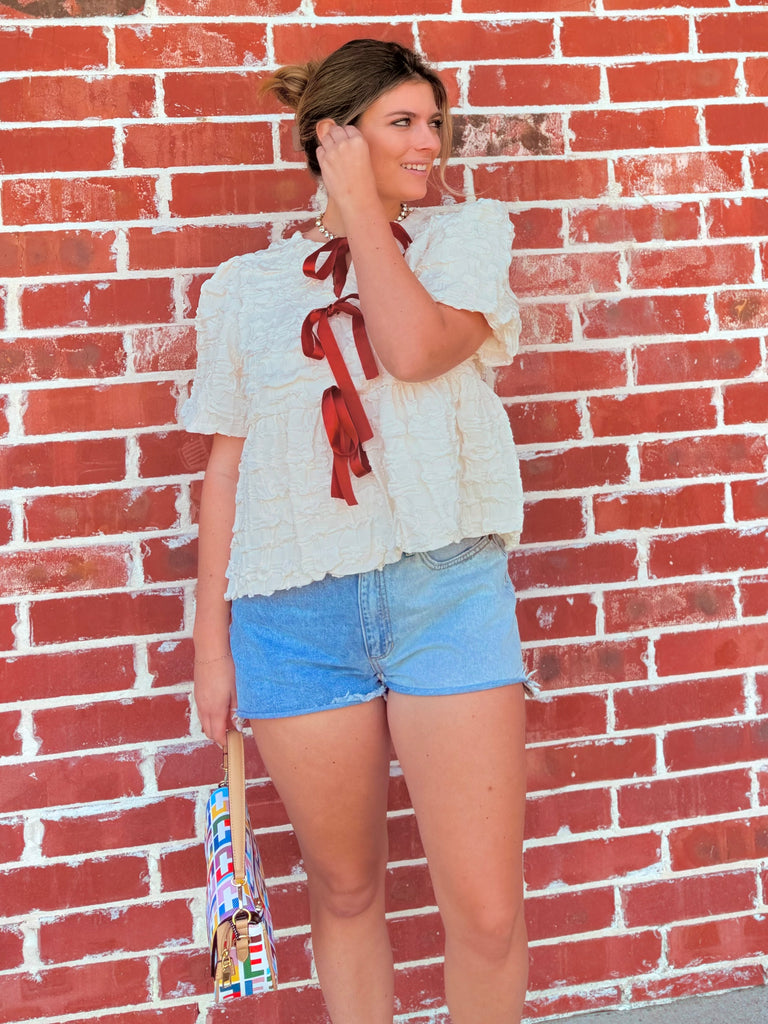 Ivory Textured Woven Peplum Bow Tie Top