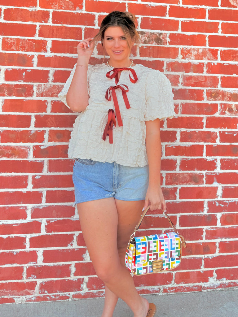 Ivory Textured Woven Peplum Bow Tie Top